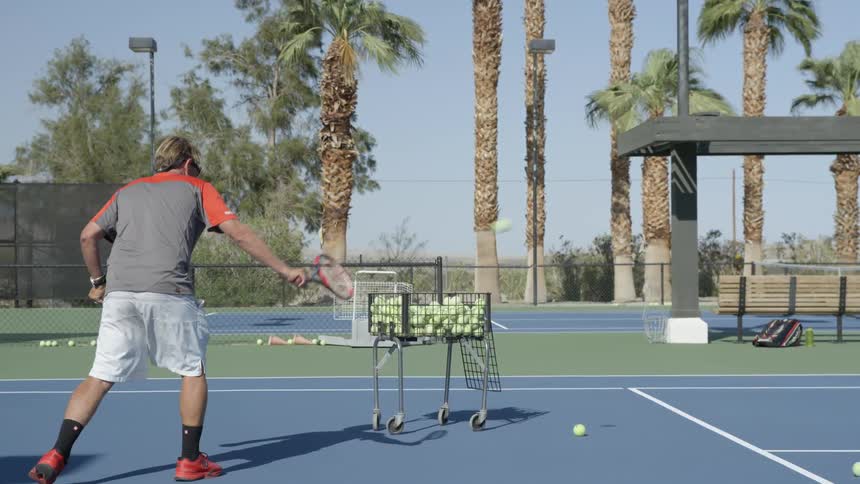 Man hitting a tennis ball on a court