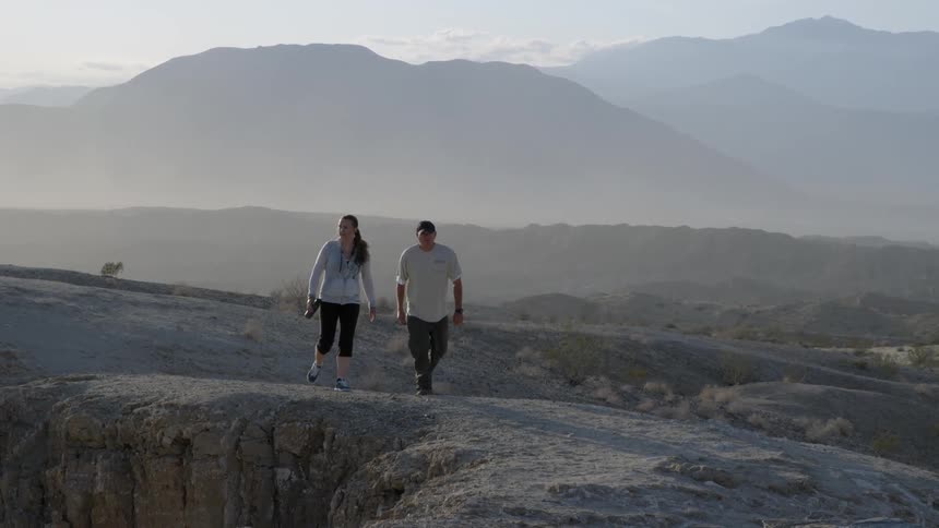 Couple walking along an elevated trail