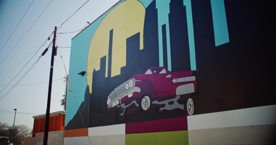 A large mural is painted on the side of the building