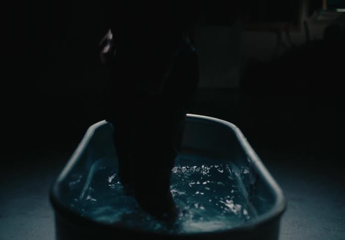 Man getting out of a bathtub in a lowlight location
