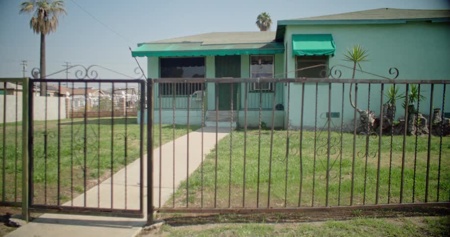 The home has an iron fence around the yard