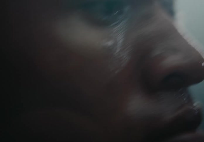 The face of a man who is running and his skin is all sweaty