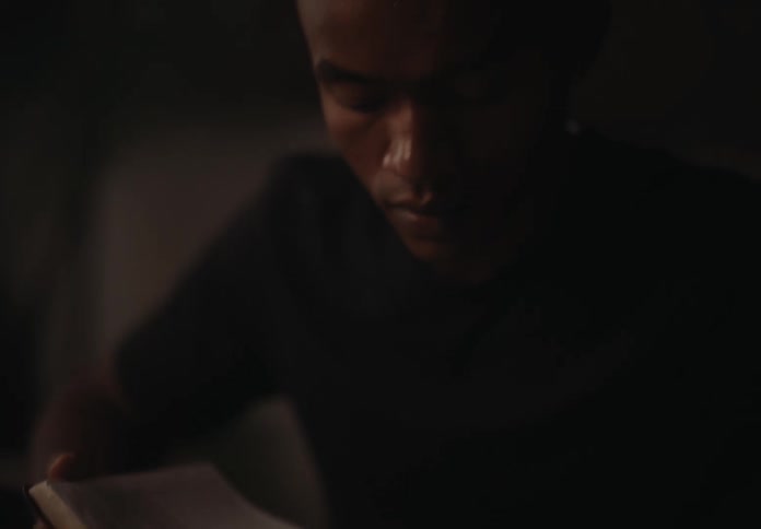 A clip of a male reading publication