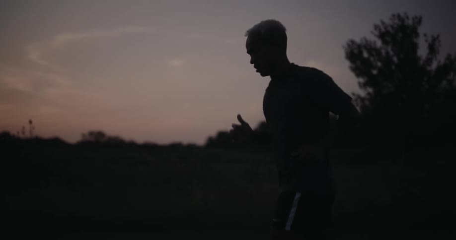 Silhouette of a man jogging on the countryside in the morning