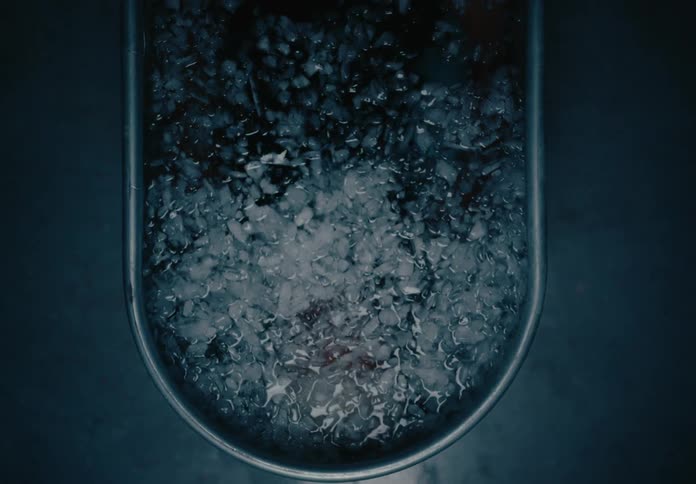 A man sits in the tub full of water and ice