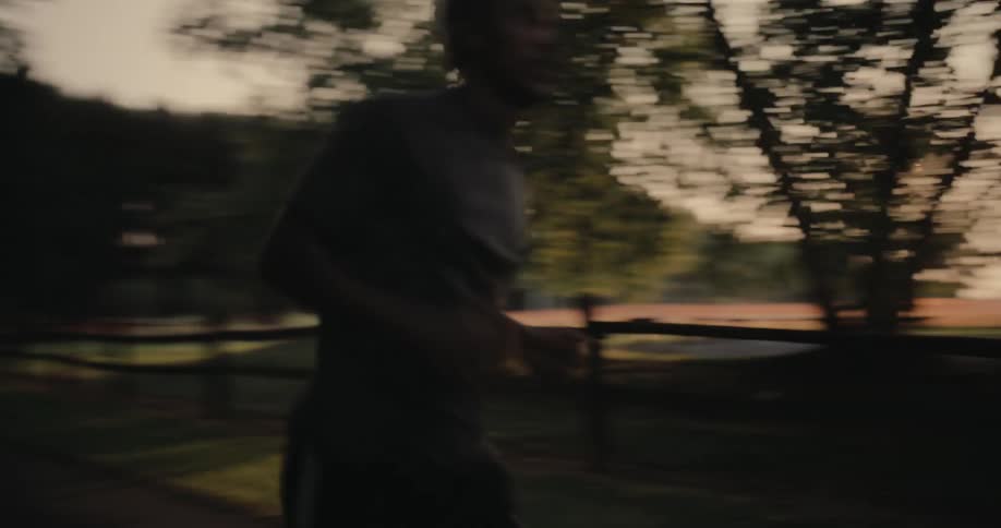 Man running in a park at the end of the day