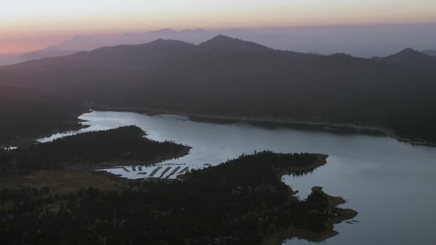 Mountains surround a lake at sunset