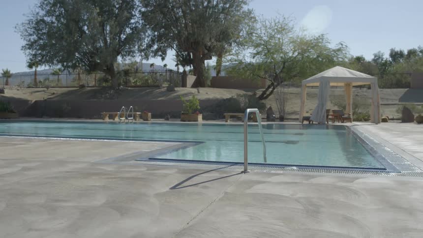 Empty swimming pool in a public setting on a clear day