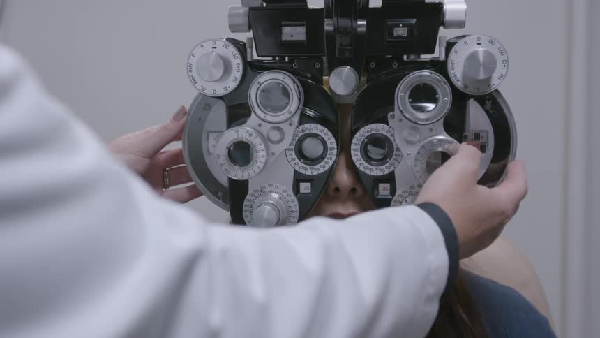 Woman looking through eye equipment