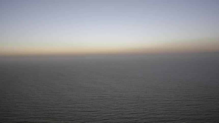 The sun sets over the ocean