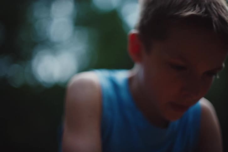 A clip of a kid on a blue tank top