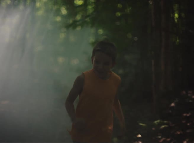 Children run together through the forest