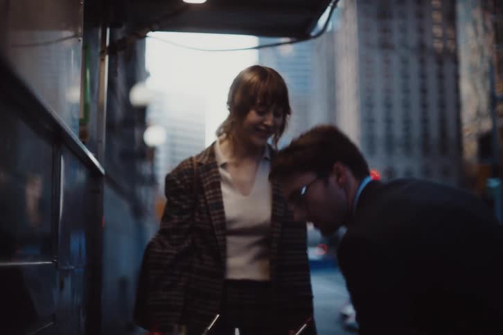 Man and woman in a food truck on the sidewalks of a metropolis