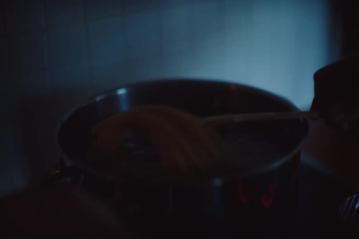 Man with a spatula cooking in a pan