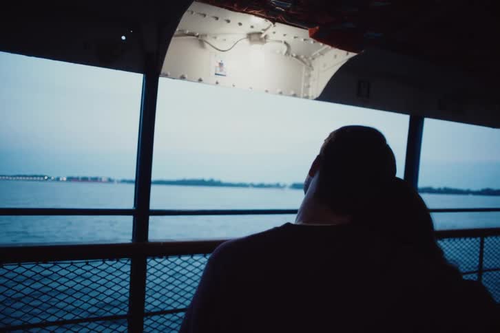 A clip of a man and woman holding each other on a boat