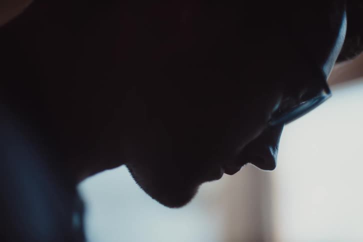 Side portrait of a concentrated man wearing glasses
