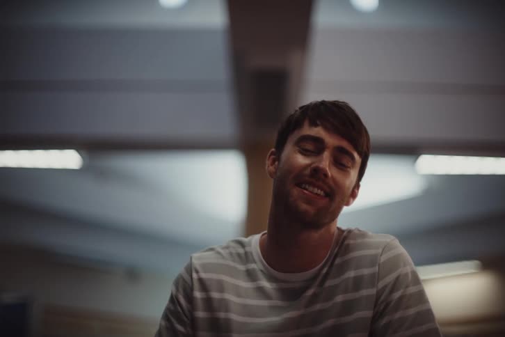 Portrait of a man sitting indoors talking