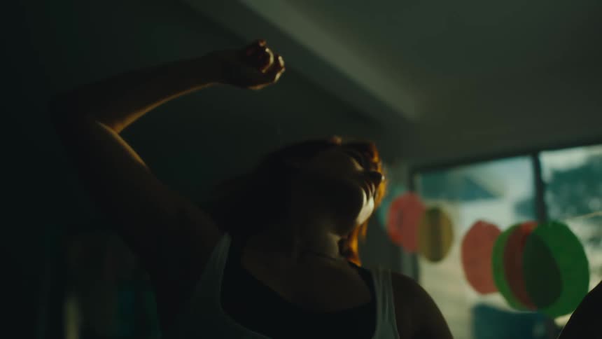 Woman in an indoor space dancing
