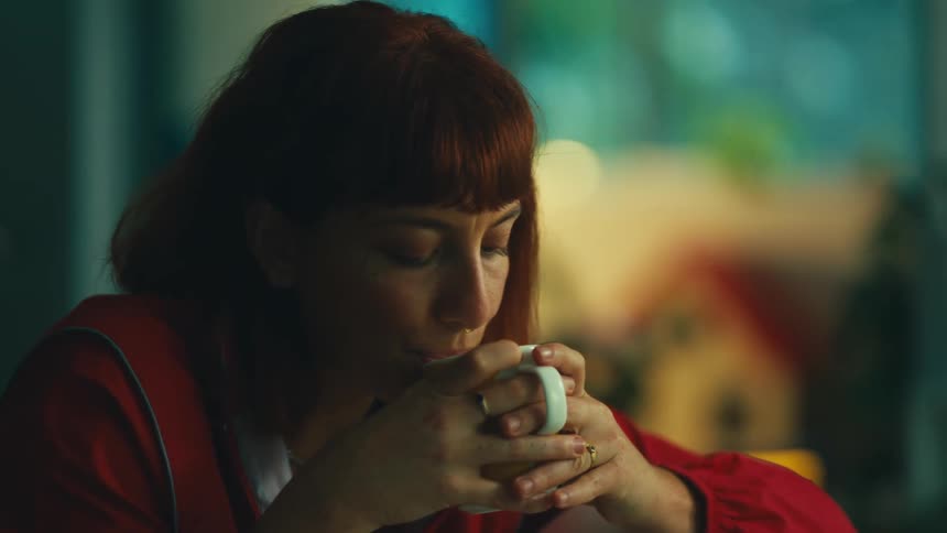 Woman sitting drinking from a mug