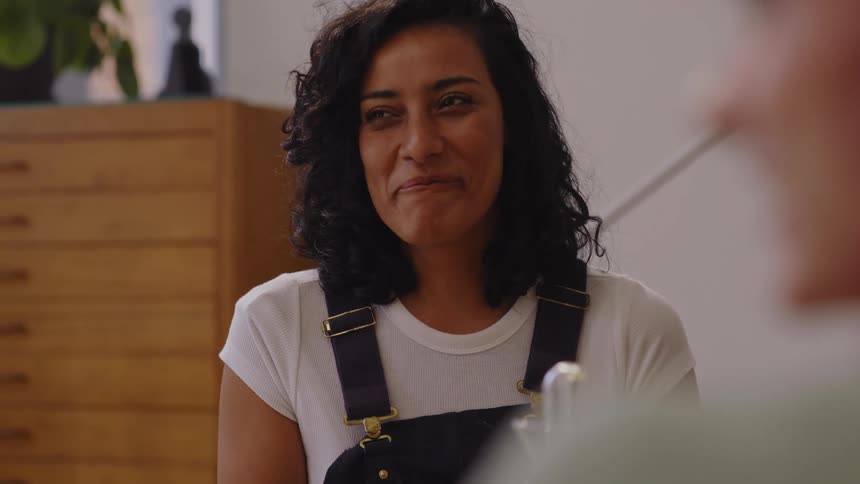 Woman laughing out loud while sitting and talking
