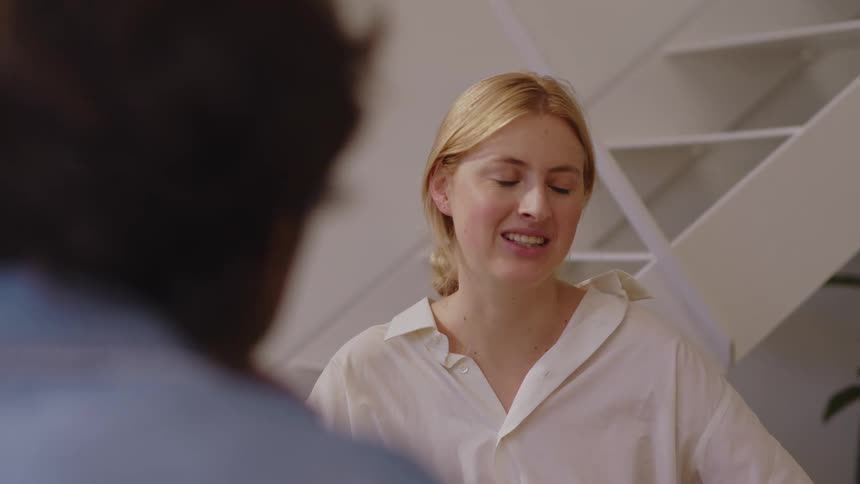Woman sitting talking to a man