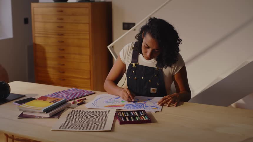 A woman is drawing with different colors