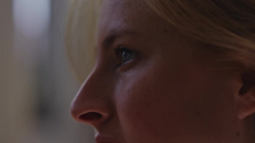A woman is talking and smiling