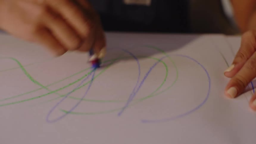 A clip of a person sketching on paper
