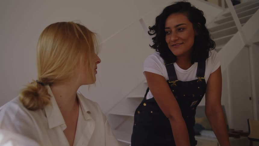 Two women are talking and smiling