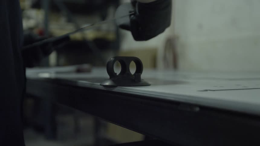 Person working with thin metal sheets in a workshop