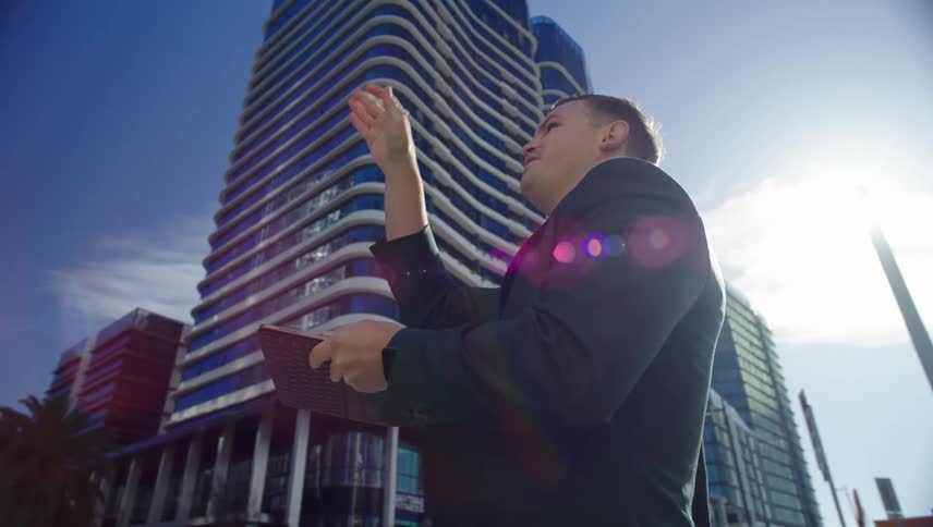 Two men are pointing toward the building