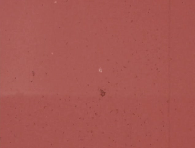 Leader marks on a red background running on vintage film