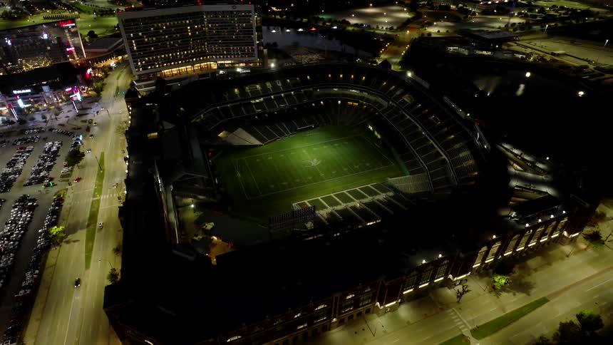 Aerial of a football stadium in an urban area at night
