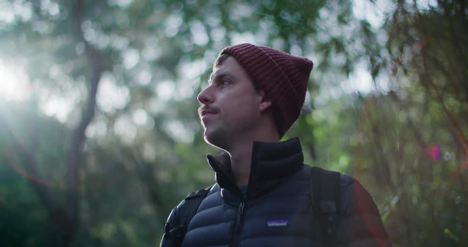 Man in a forest taking a deep breath