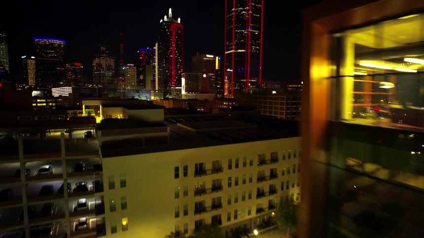 Night view of a city with a modern lighted glass building