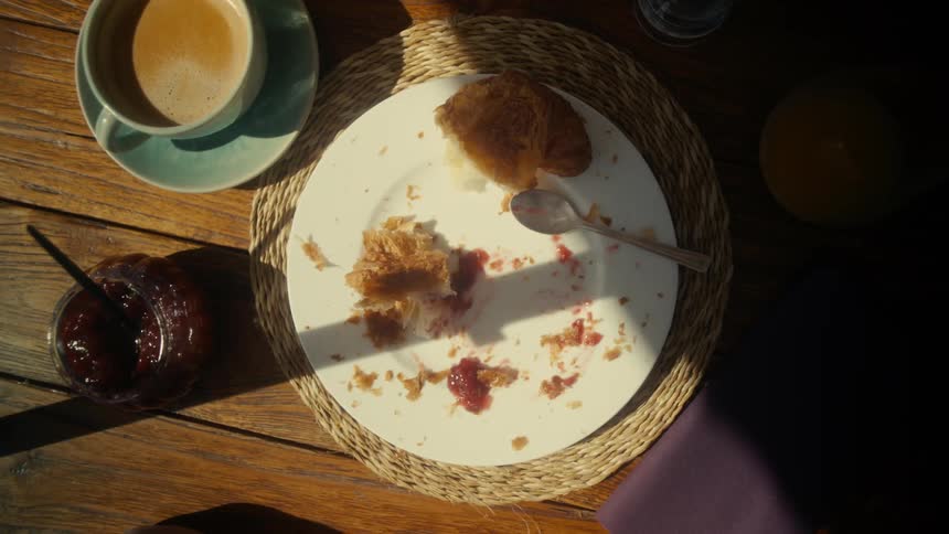 Hands taking a piece of bread with jam