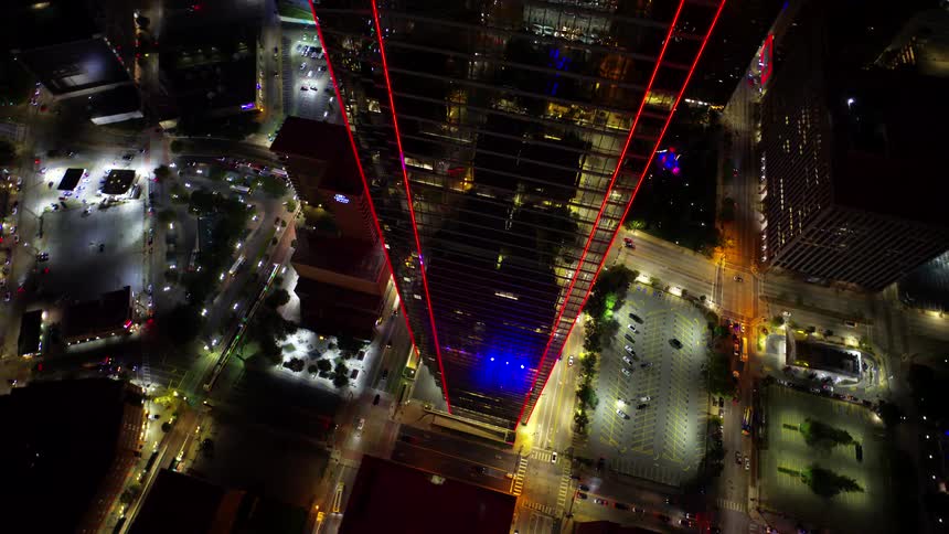 A tall skyscraper glows at night