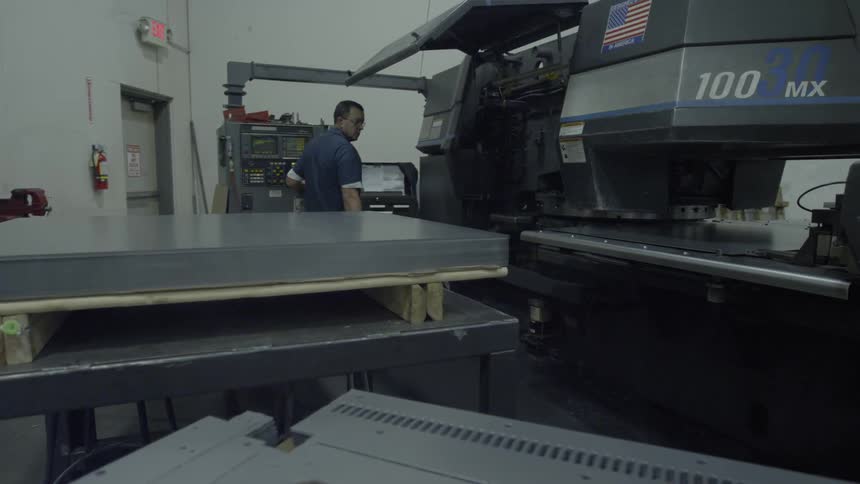 Man operating a machine in a factory
