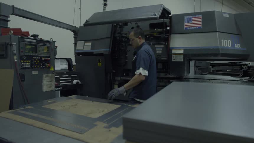 Man working in a factory with machinery all around