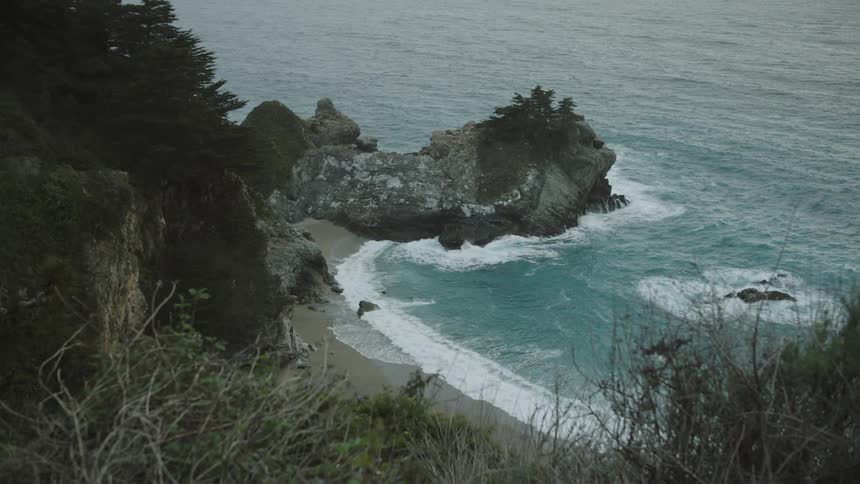 A small cove beach is seen from above