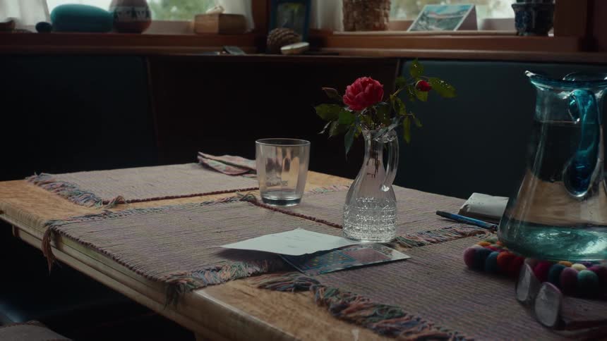 A handwritten note with a lottery ticket sits on a dining room table