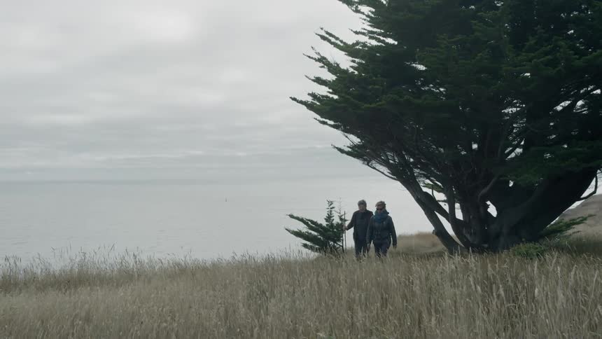 Two women are hiking on a windy day