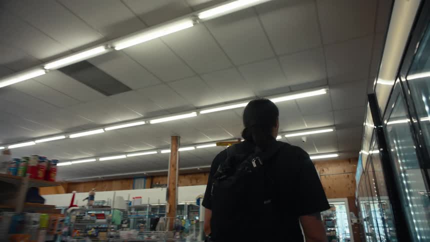 A man is walking through the store