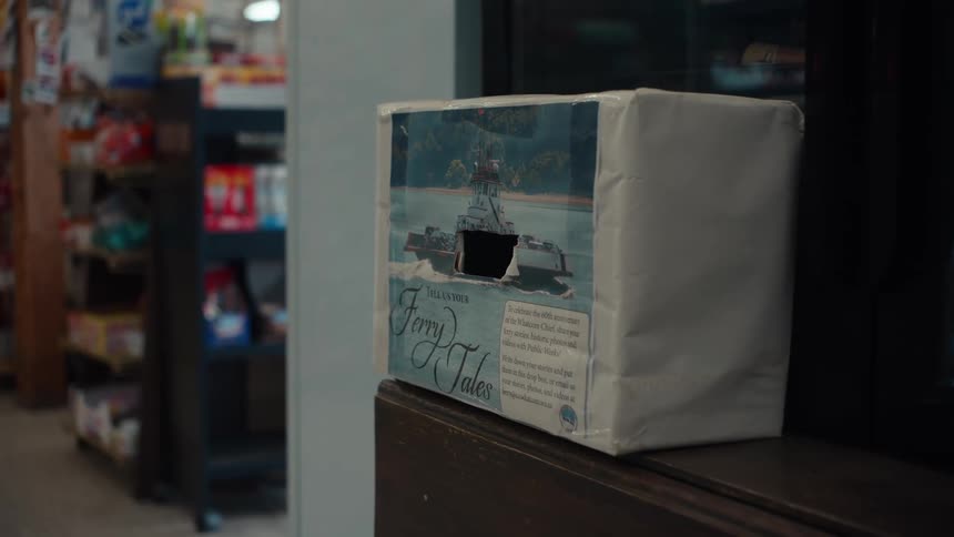 Cardboard box covered with white paper with a rectangular cutout on the front