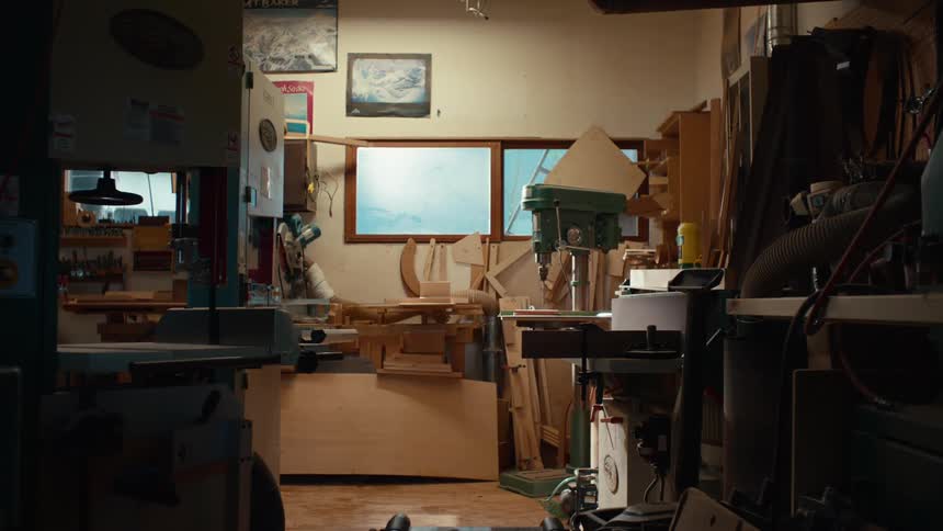 A cluttered woodworking workshop filled with tools and materials