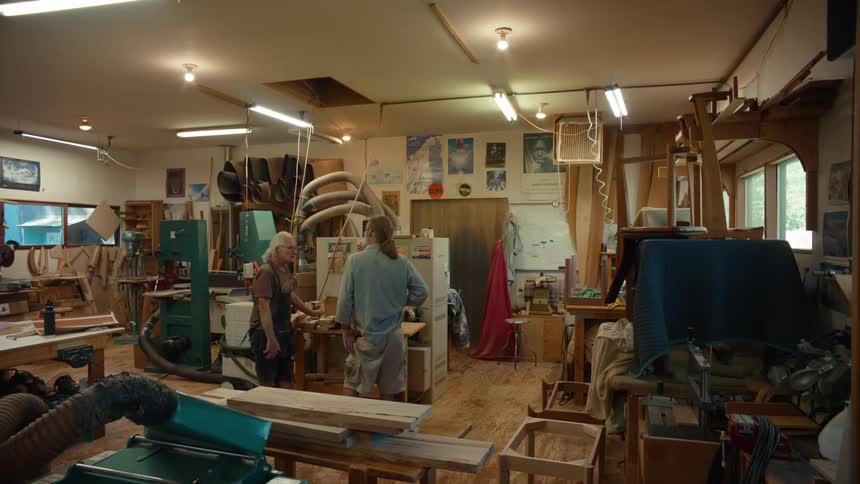 Two men working in a carpenters shop