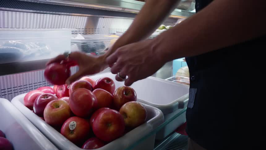 Man picking up an apple
