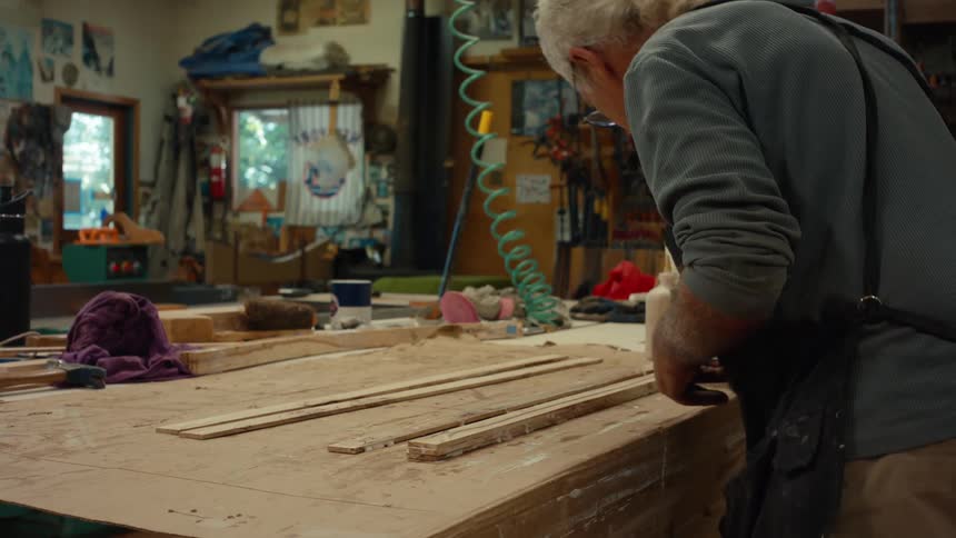 Man applying wood glue to a piece of wood