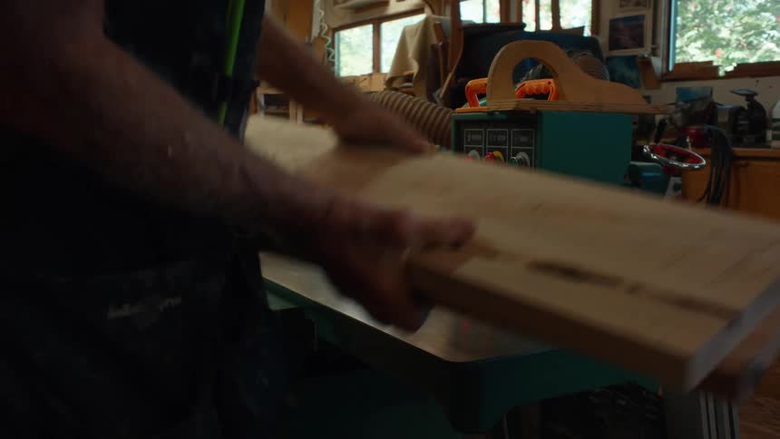 People working on a well equipped woodworking workshop