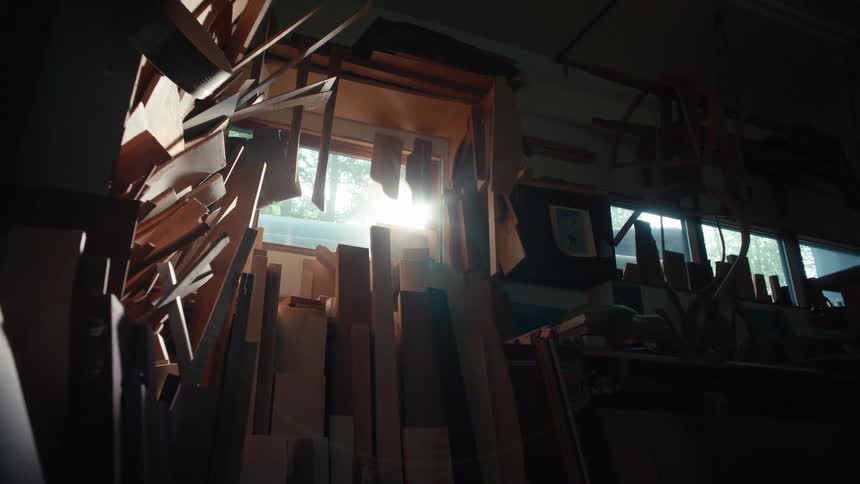 Sunlight filters through the window of a woodworking workshop